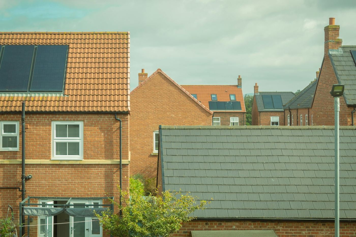 All-black solar panels on brick semi-detached houses on a UK estate